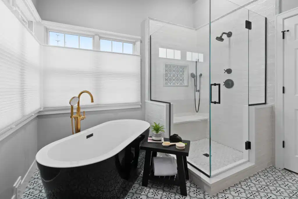 Master bathroom layout in Palatine featuring a black freestanding tub, glass enclosed shower with black hardware, and a built-in quartz shower bench.