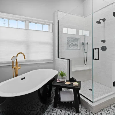Master bathroom layout in Palatine featuring a black freestanding tub, glass enclosed shower with black hardware, and a built-in quartz shower bench.